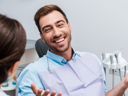 man laughing in exam chair