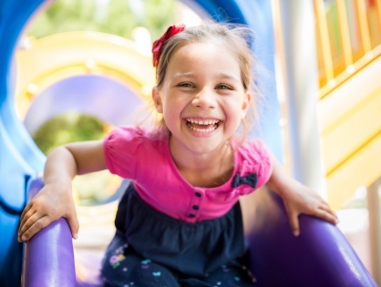 little girl smiling on playground