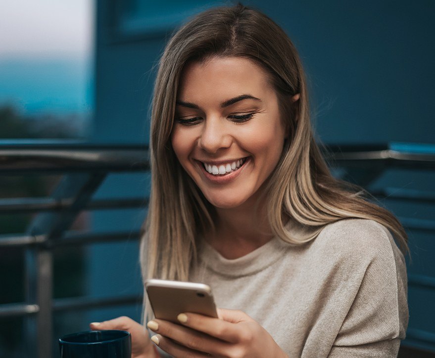 woman holding coffee cup and smiling