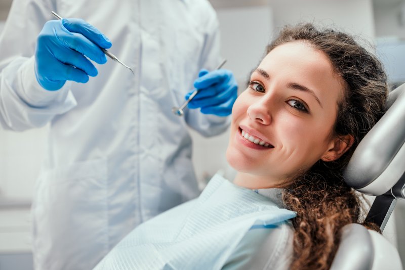 female patient smiling in the dentist’s chair